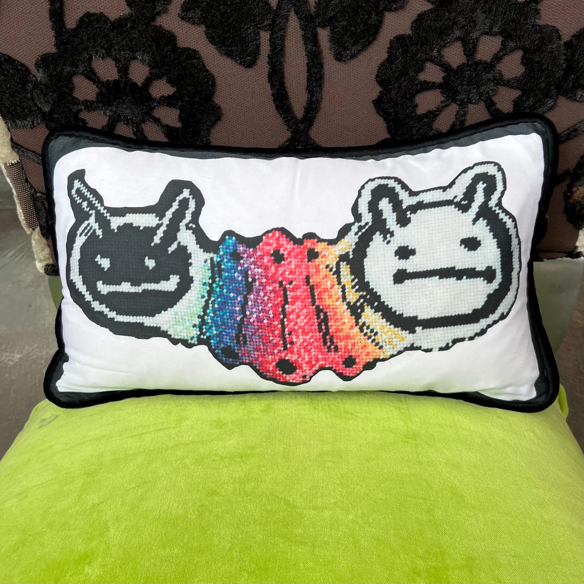 two headed, horned worm connected with a shared rainbow body
