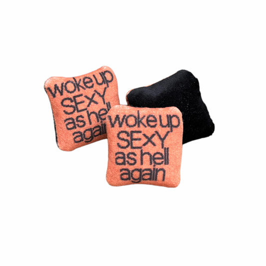woke up sexy as hell again centered on pillow in black text with copper background