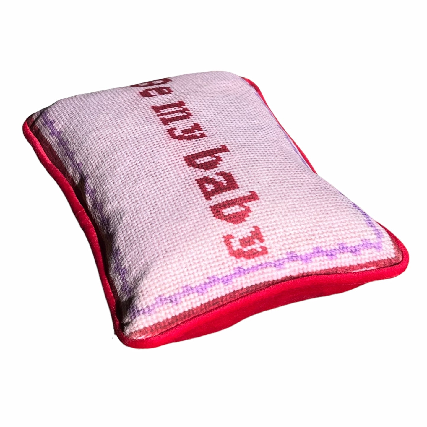 Pink velvet pillow with red letters that say "Be My Baby"; lavender wavy border.