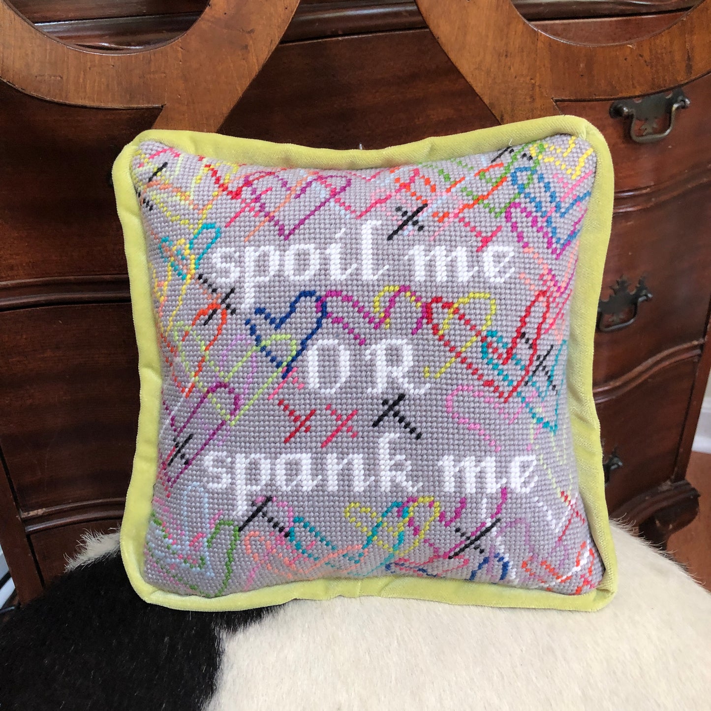 hand-embroidered needlepoint SPOIL ME or SPANK ME pillow