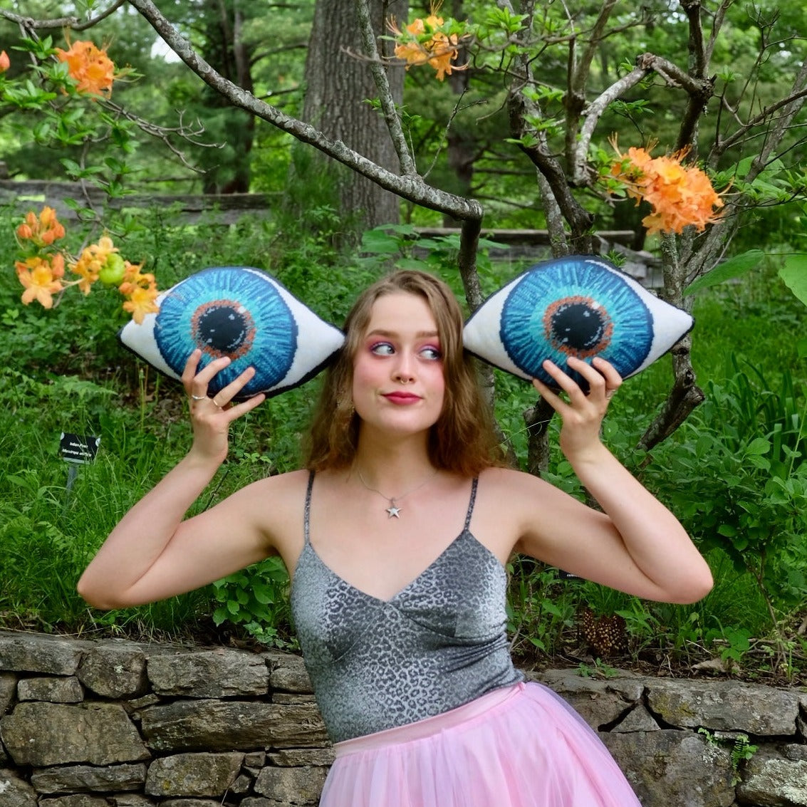 blue eye sculpted pillow has gold in center, turning to turquoise, then deep blues blond model