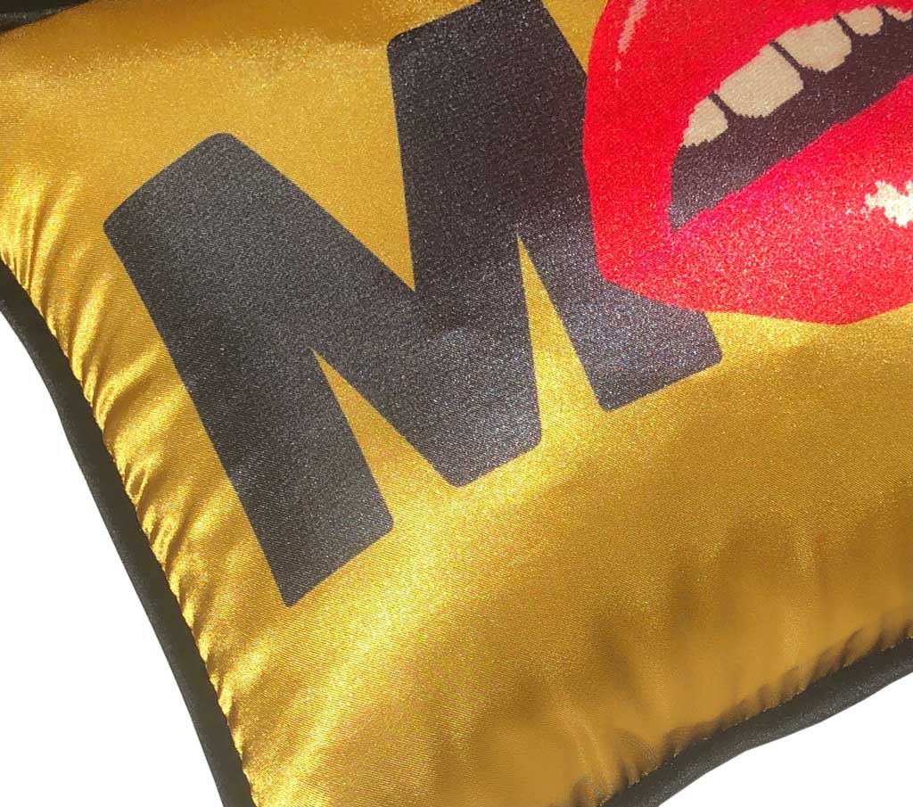 gold satin pillow with MOI written in black, red lips replacing the O
