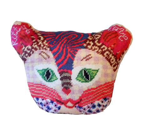 Multi-patterned sculpted cat in primarily pink and red colored with a checked face, swirls, leopard print , green eyes & flowers. Kitty Love is written on the ears.