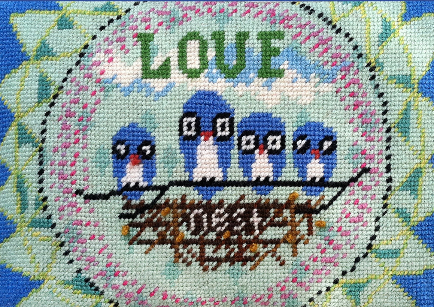 blue owls sit on next with pink circle and blue-green sun elements behind them