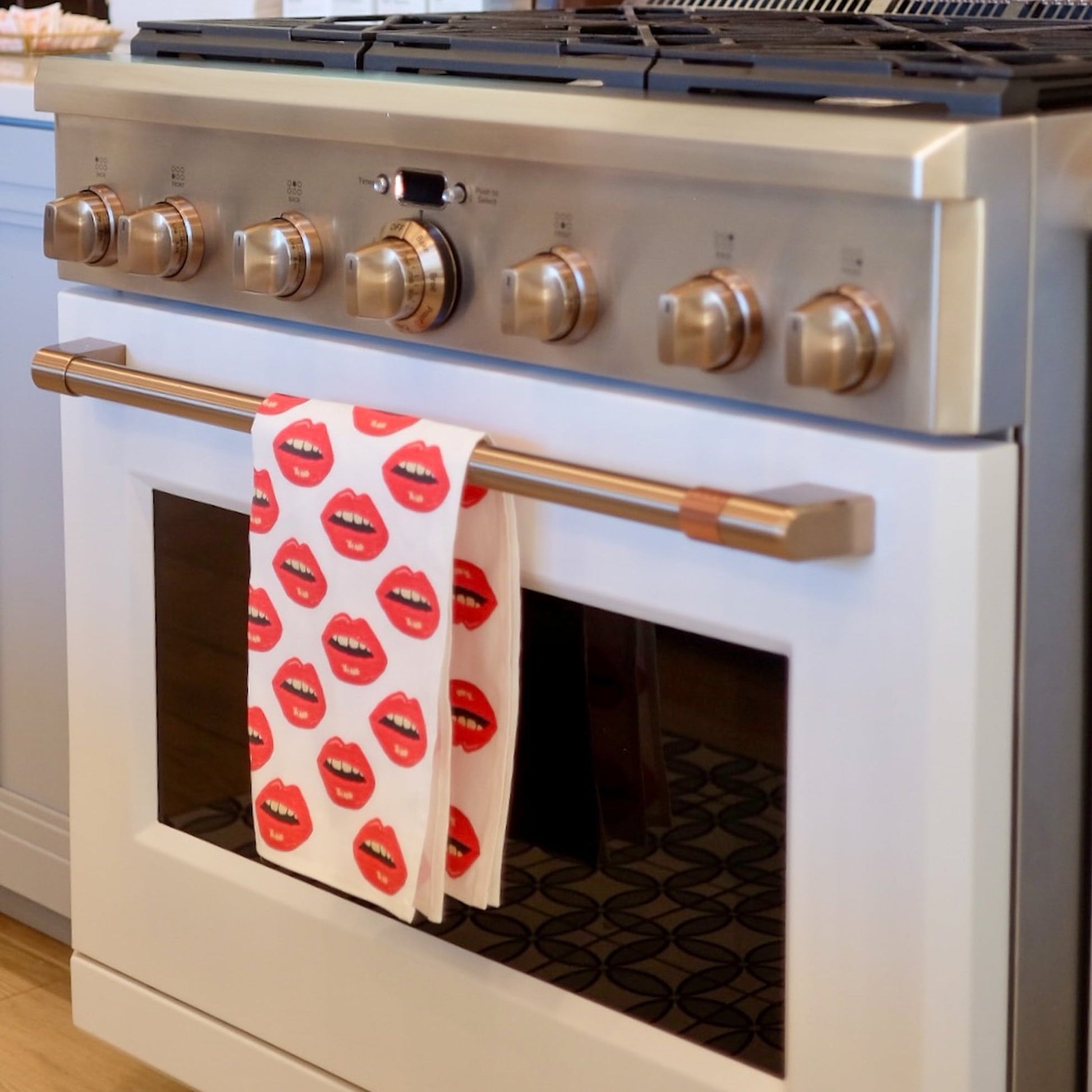 white cotton linen tea towel with red lips all over