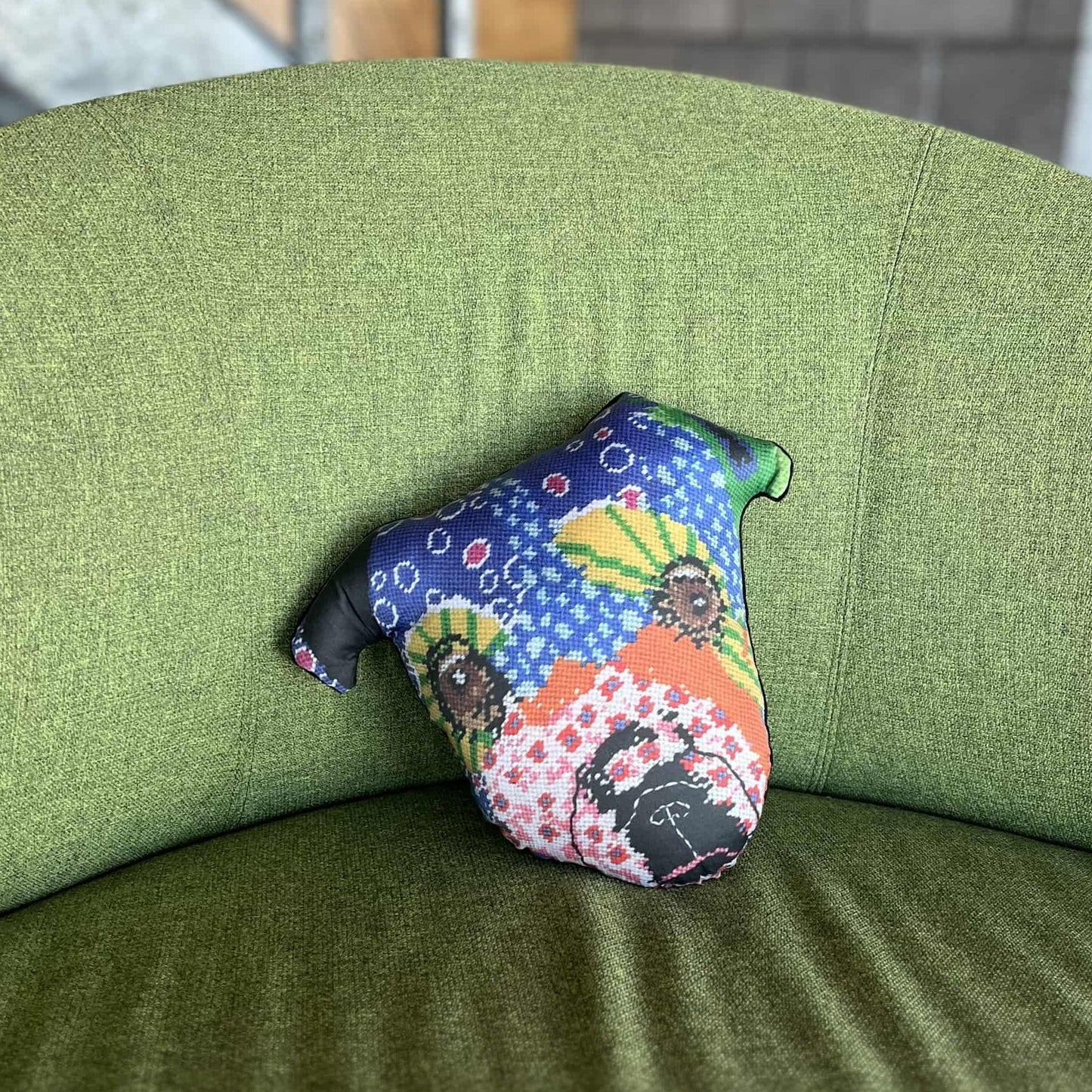 whimsical dog pillow with brown starry eyes, pink flowers, purple dots, pink flowers