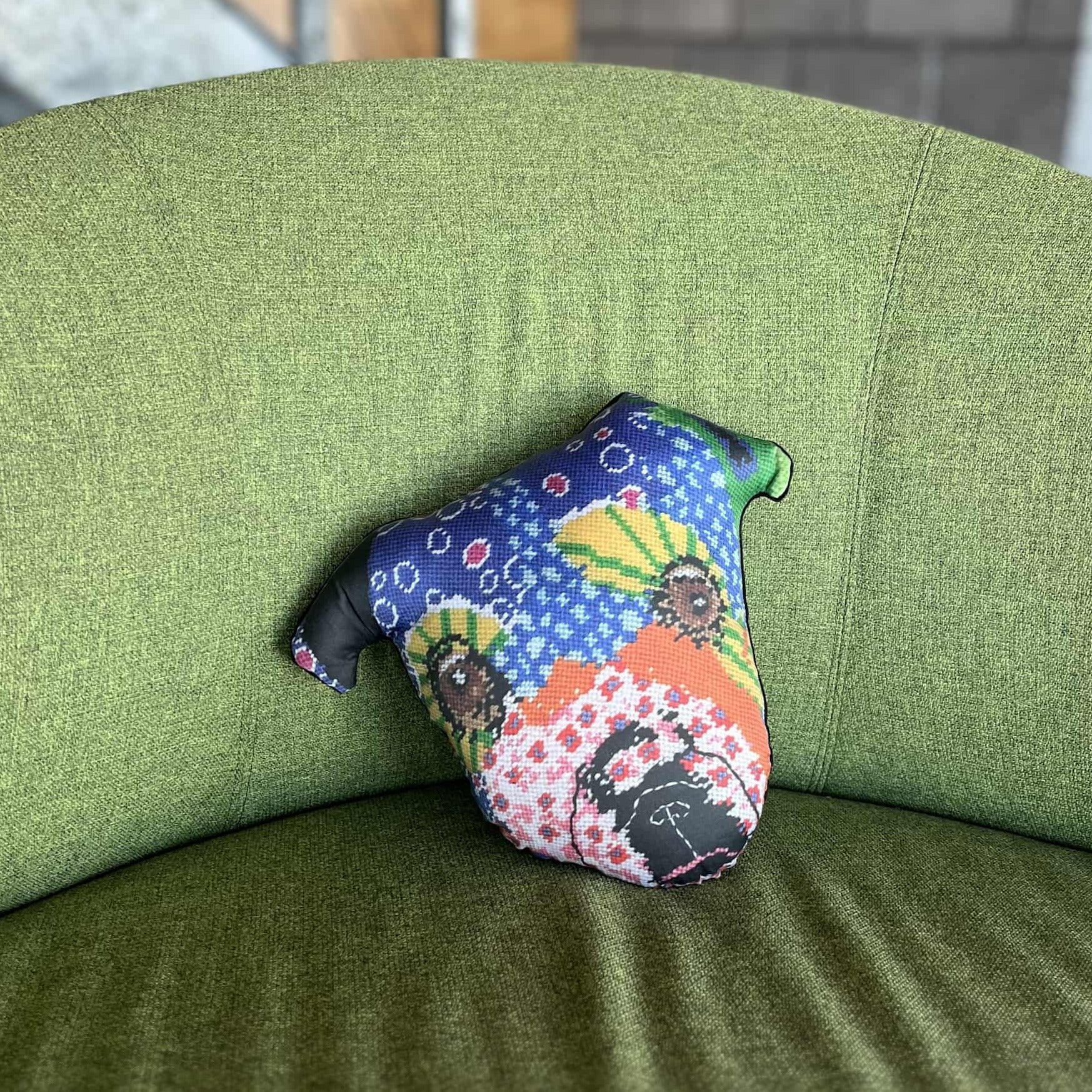 whimsical dog pillow with brown starry eyes, pink flowers, purple dots, pink flowers