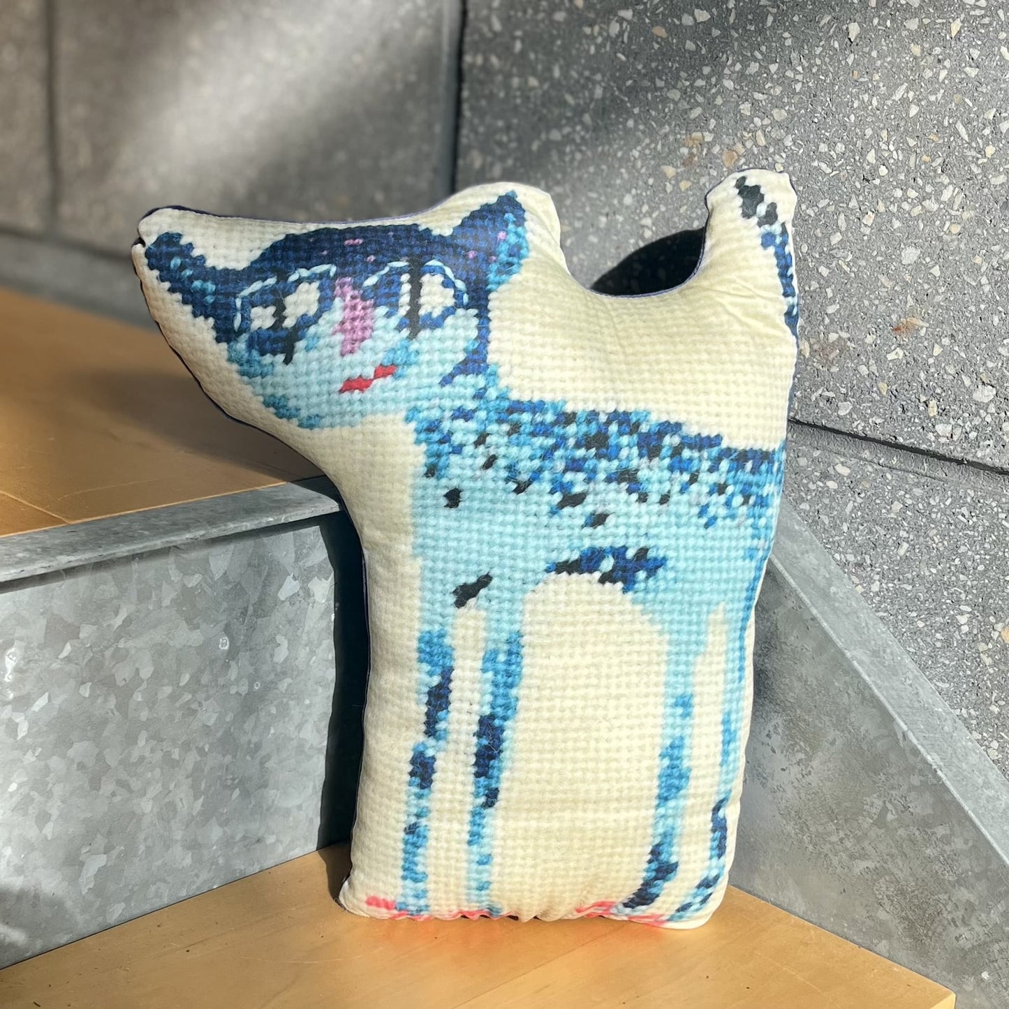 sculpted blue cat with big eyes, pink toenails and tail in the air
