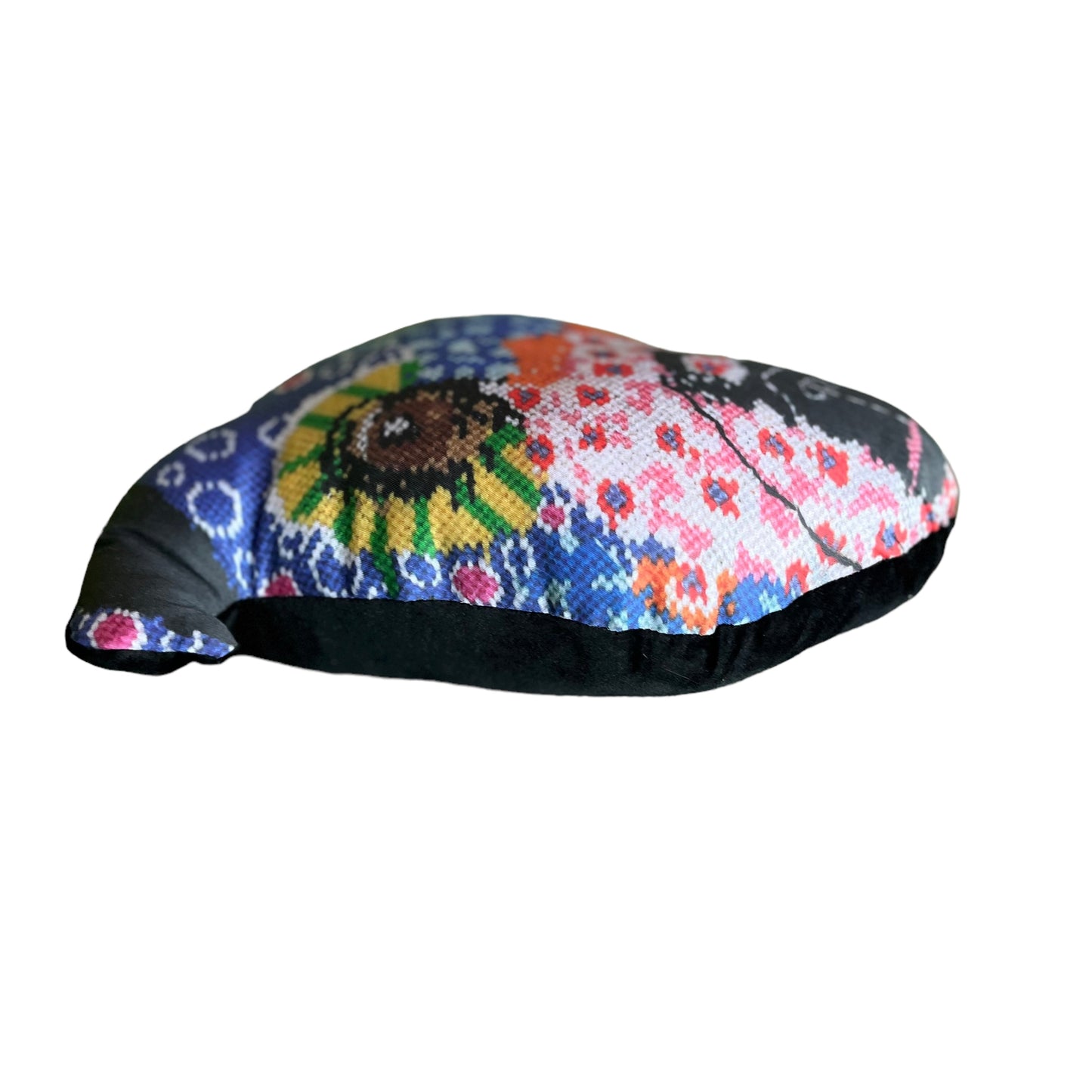 whimsical dog pillow with brown starry eyes, pink flowers, purple dots, pink flowers