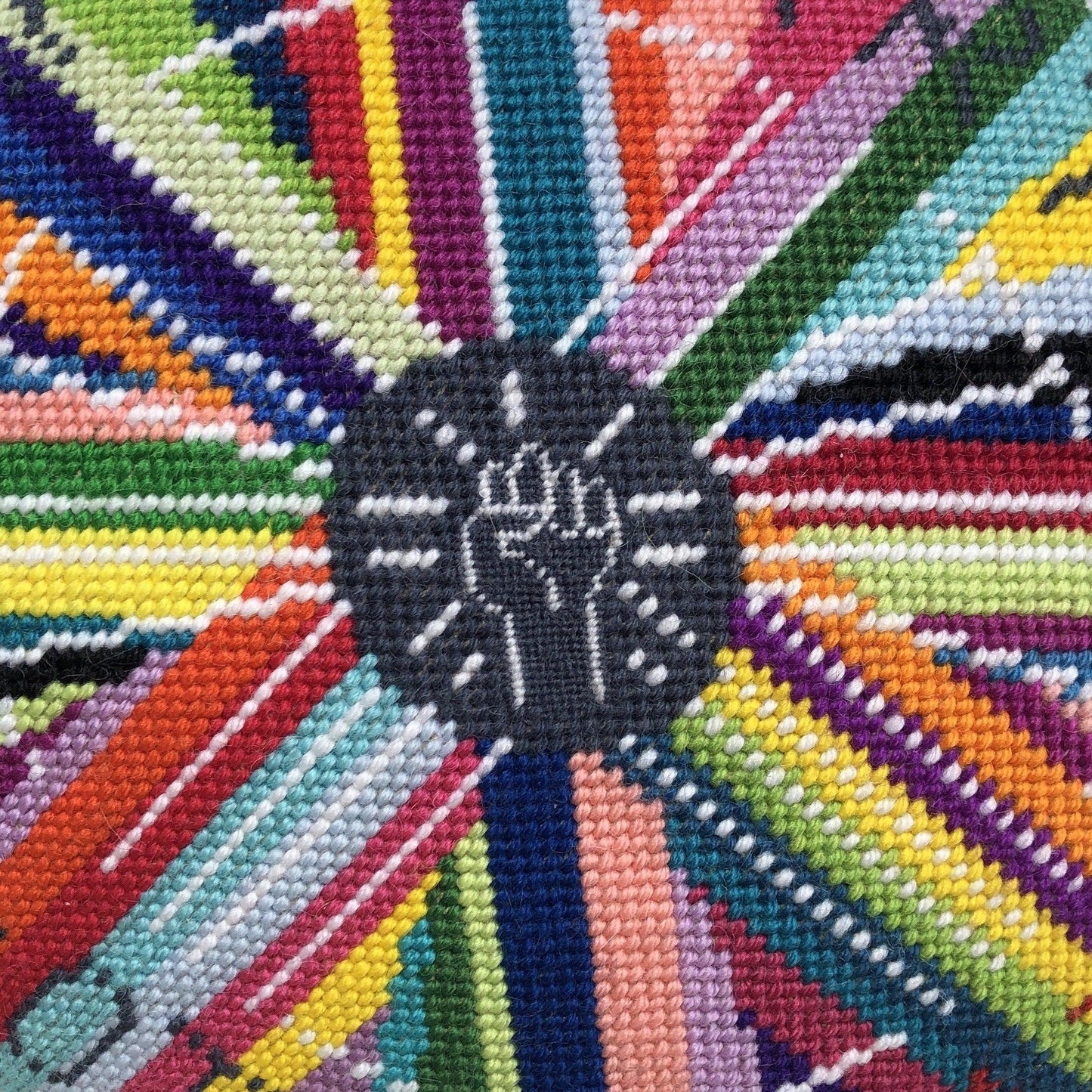 pillow center is dark gray with white fist pump, rainbow circle radiates out with GONNA START A REVOLUTION, cloud and stars border