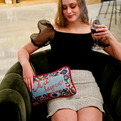 designer velvet pillow reads "Chic Happens" in red on Tiffany blue background with colorful red, green and blue  large paisley border