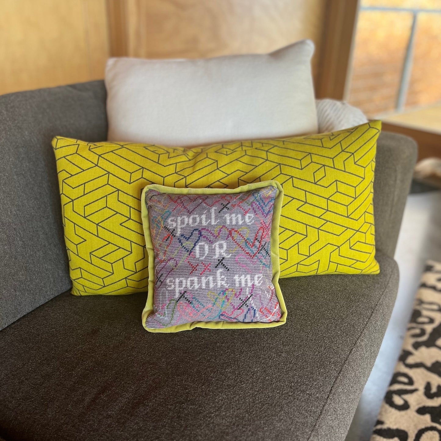 hand-embroidered needlepoint SPOIL ME or SPANK ME pillow