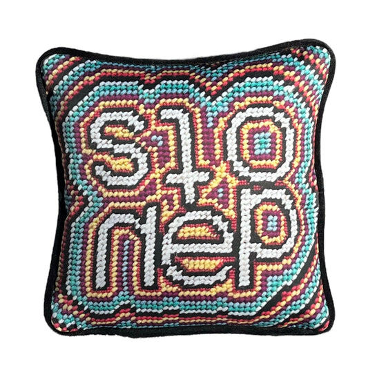 pillow reads STONED in crazy shaped letters
