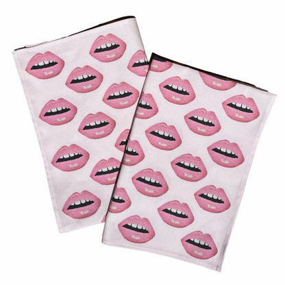 linen-colored tea towel with soft pink lips covered all over it