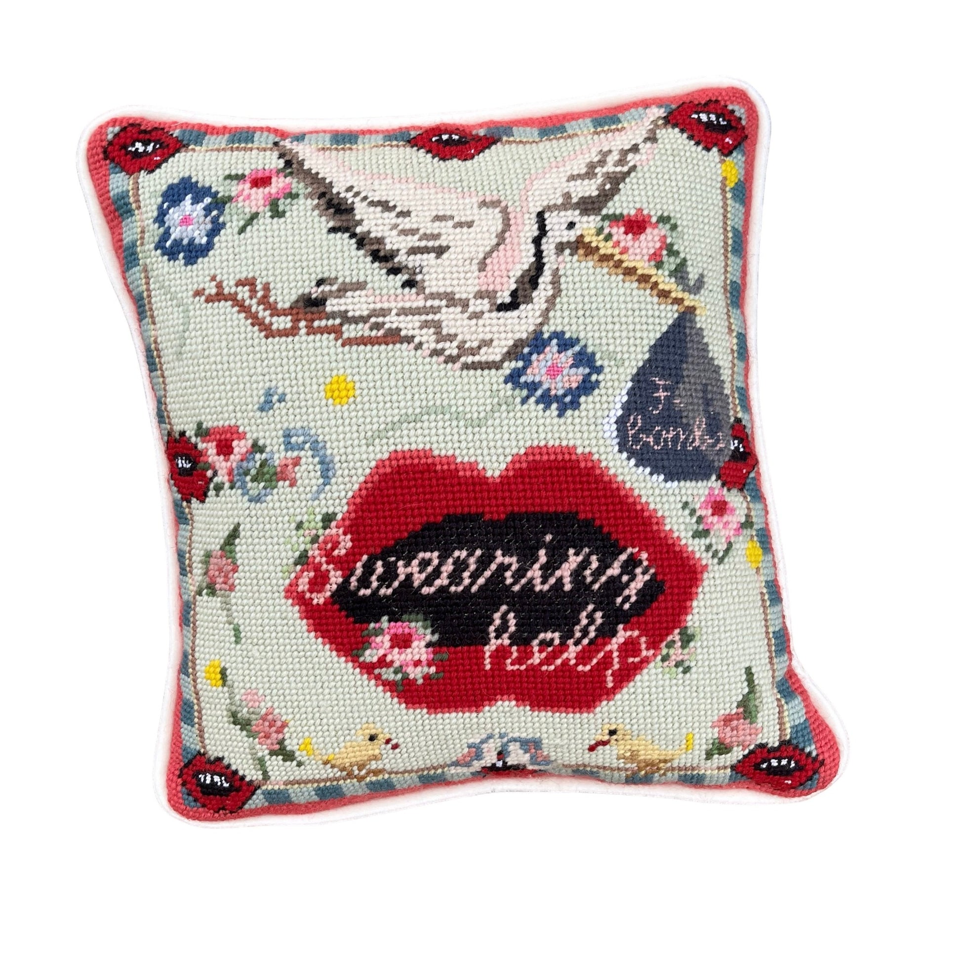 funky needlepoint pillow with stork carrying f-bombs and big lips
