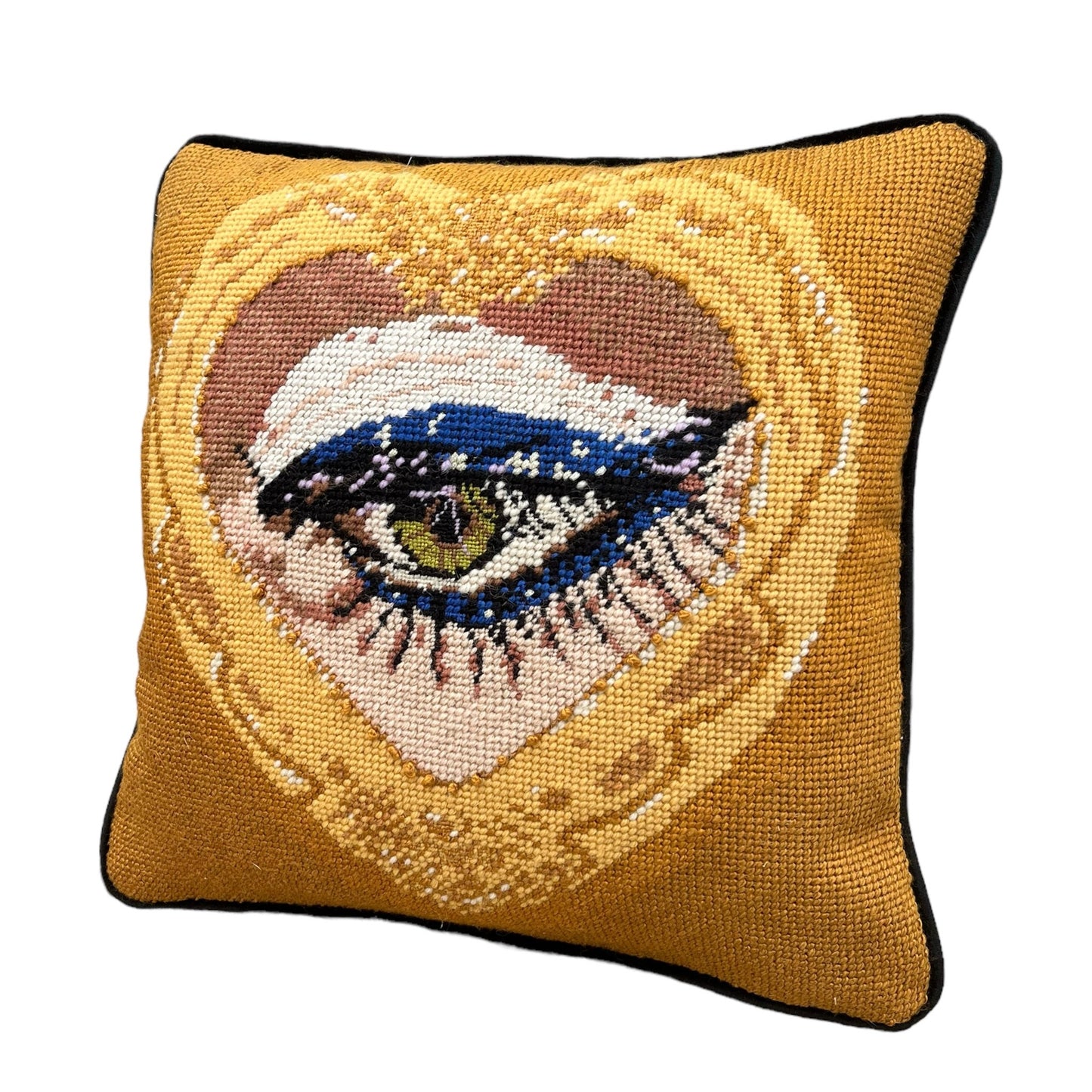 sultry green eye is framed in gold heart, hand-embroidered wool & silk pillow