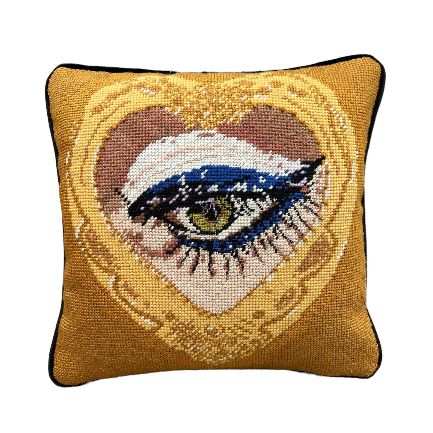 sultry green eye is framed in gold heart, hand-embroidered wool & silk pillow