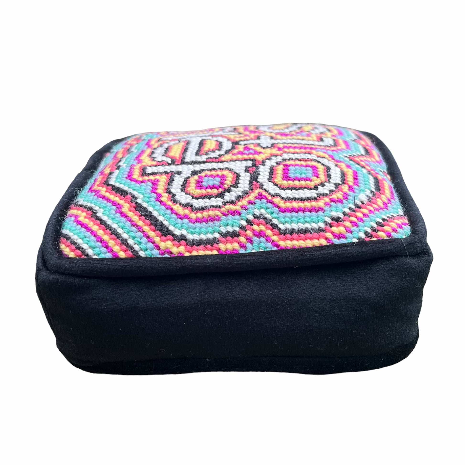 objet d'art pillow features psychedelic, colorful pattern with the word stoned in the center
