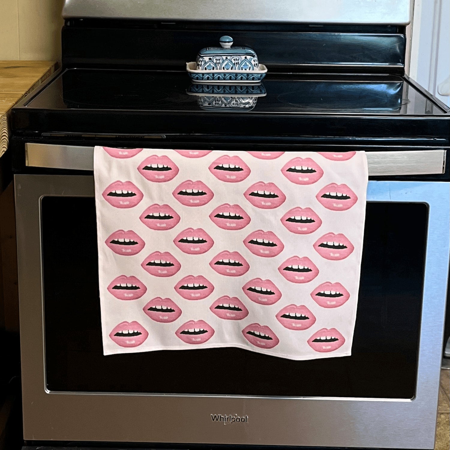 linen-colored tea towel with soft pink lips covered all over it