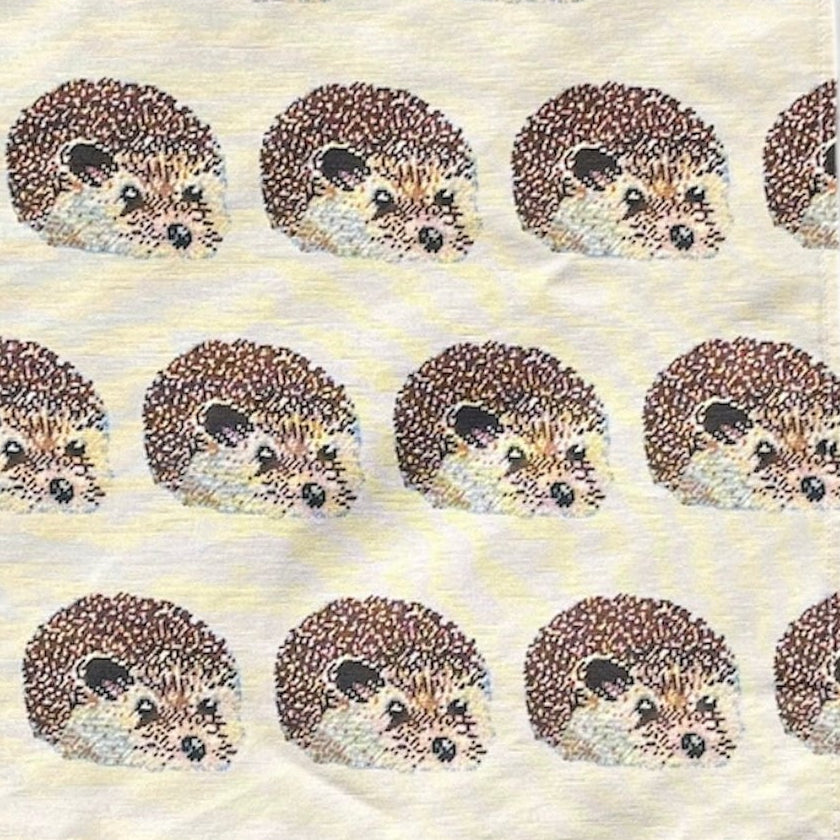 Tea towel with hedgehog pattern on a white background