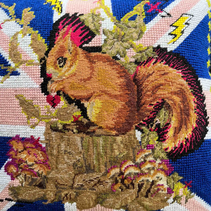squirrel with hot pink mohawk sits on a tree stump, surrounded by mushrooms and British flag