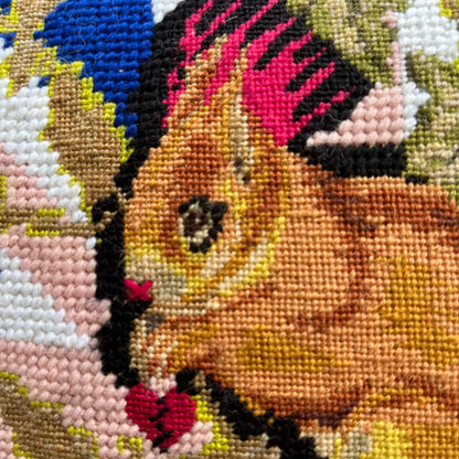 squirrel with hot pink mohawk sits on a tree stump, surrounded by mushrooms and British flag
