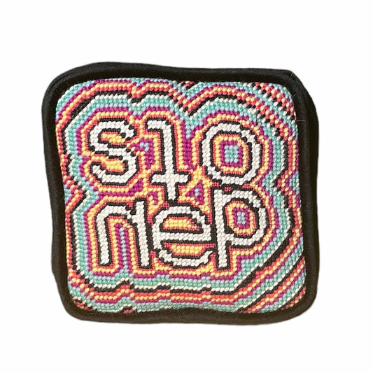objet d'art pillow features psychedelic, colorful pattern with the word stoned in the center