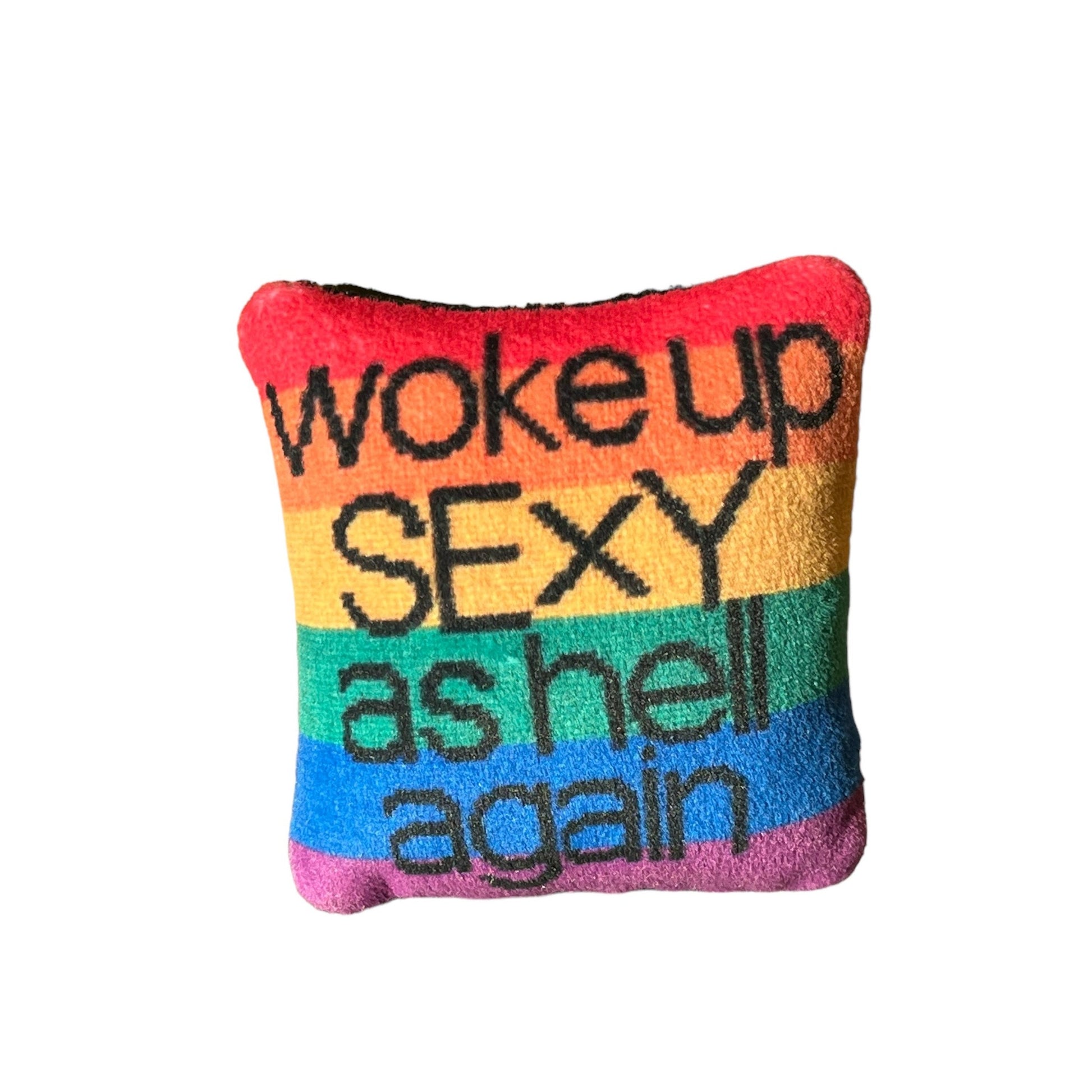 black text with woke up sexy as hell again centered on pillow on rainbow flag background