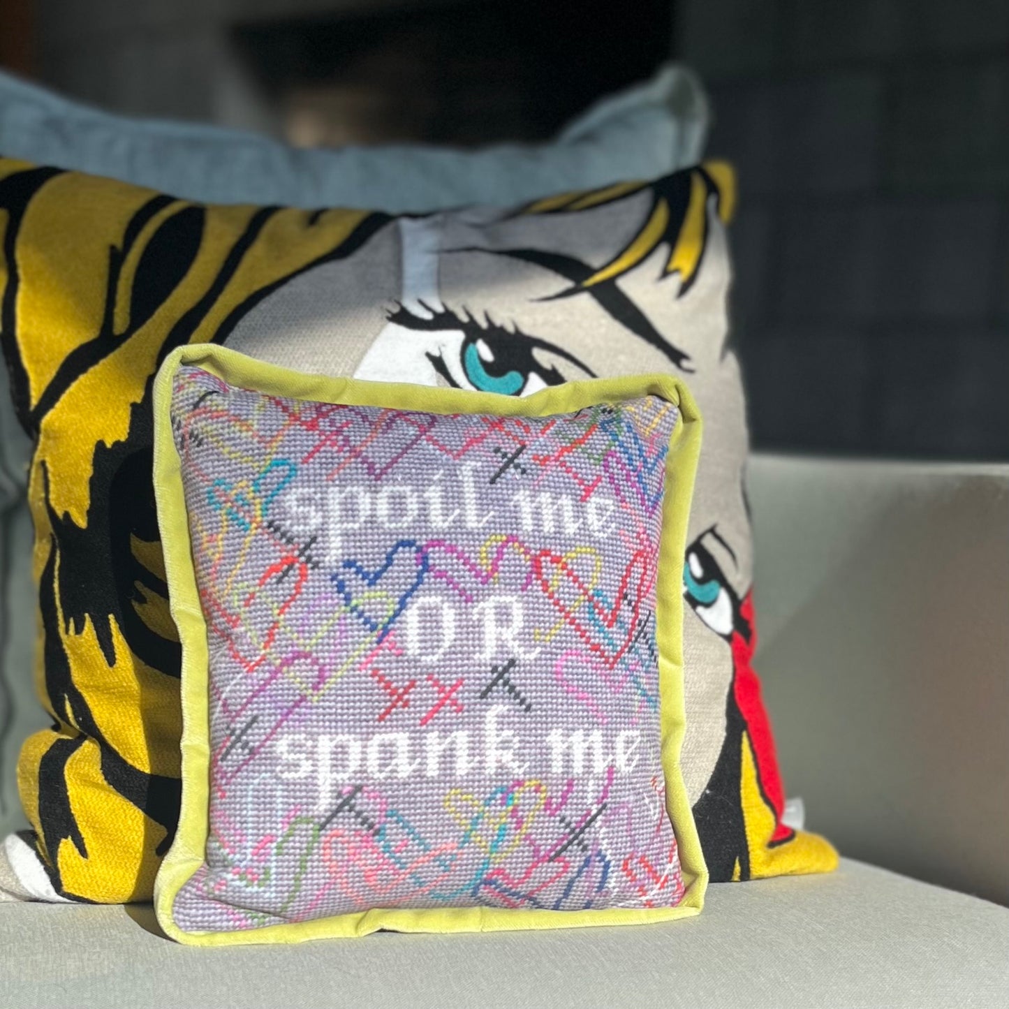 hand-embroidered needlepoint SPOIL ME or SPANK ME pillow