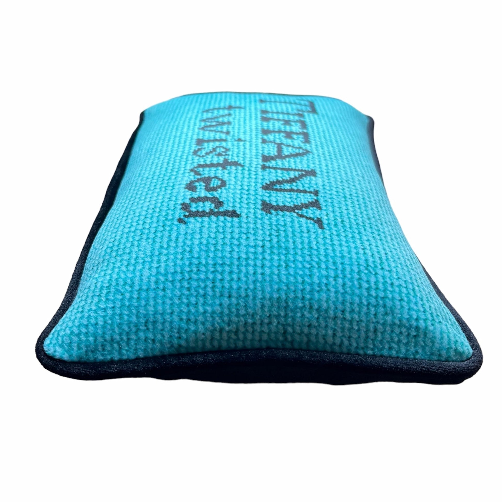 Tiffany blue pillow with black letters reading "Tiffany Twisted"