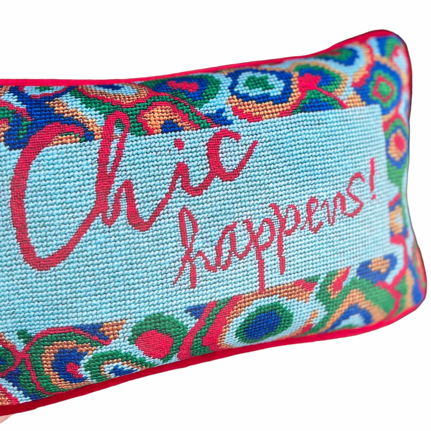 designer velvet pillow reads "Chic Happens" in red on Tiffany blue background with colorful red, green and blue  large paisley border