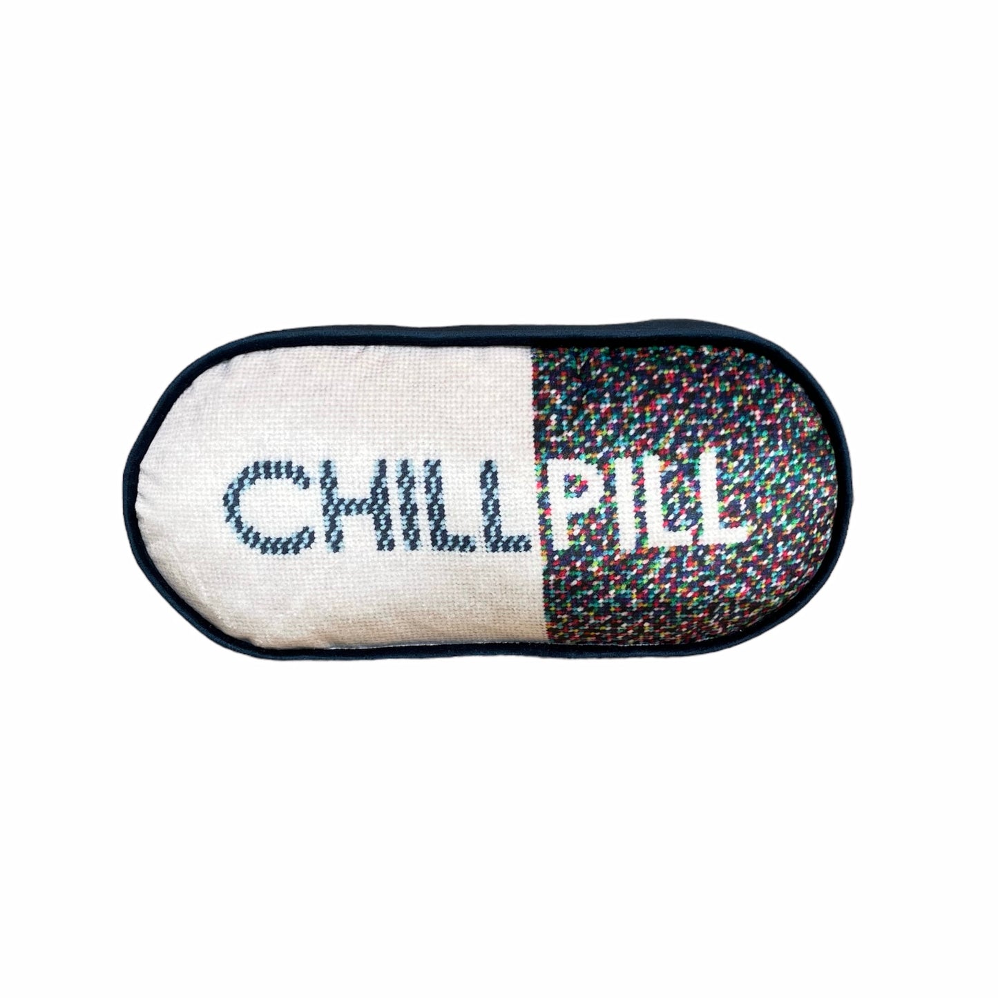 pill shaped pillow with CHILL PILL centered; 1/2 white background and multi-colored dots on the word PILL