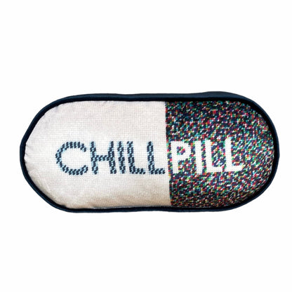 pill shaped pillow with CHILL PILL centered; 1/2 white background and multi-colored dots on the word PILL