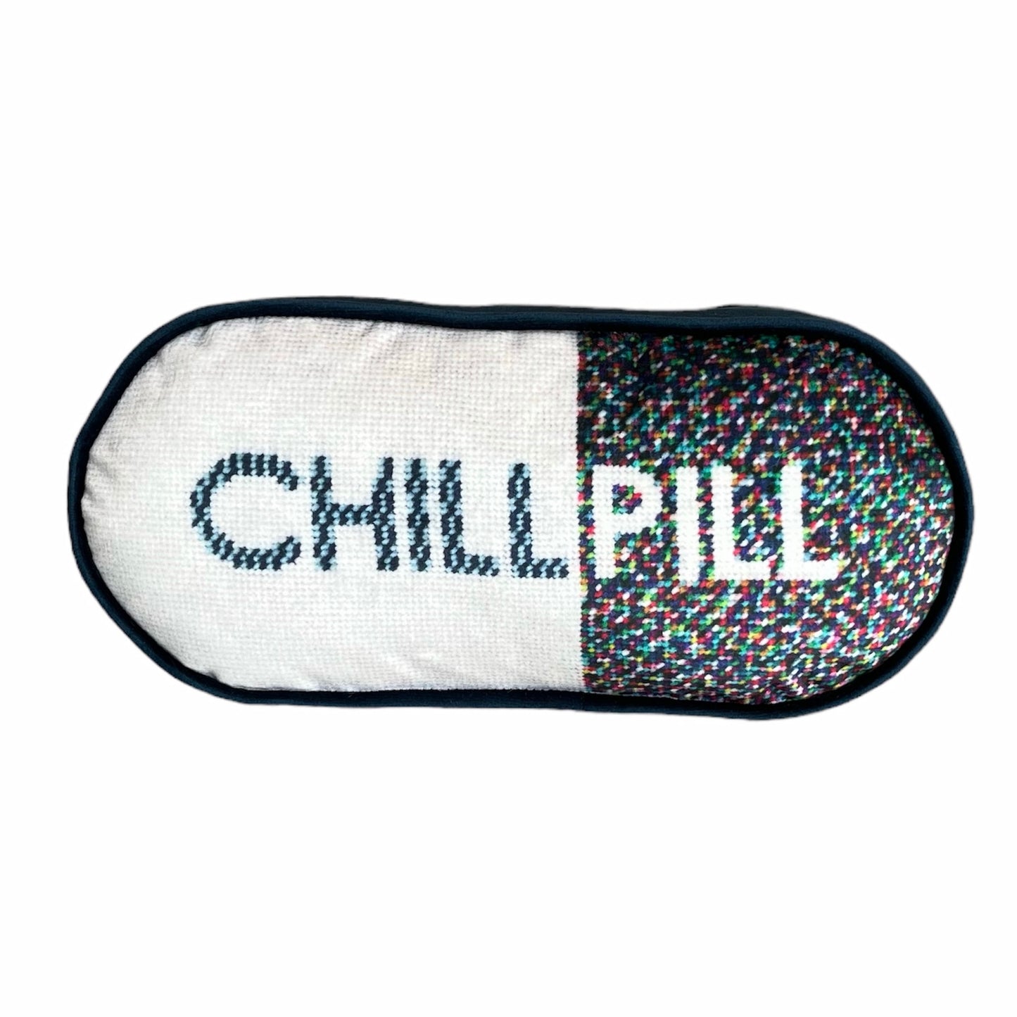 pill shaped pillow with CHILL PILL centered; 1/2 white background and multi-colored dots on the word PILL