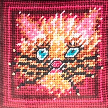 wild blue eyed cat in whimsical gold and pink with pinkish frame