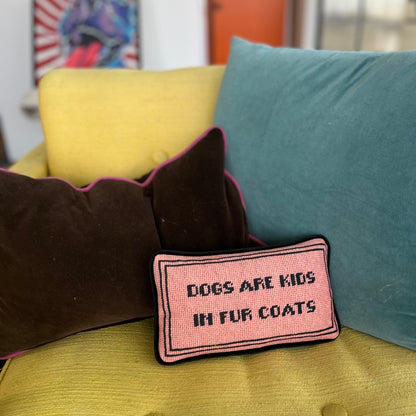 velvet toss pillow features peach fuzz background with DOGS ARE KIDS IN FUR COATS block letters centered with thin black double frame