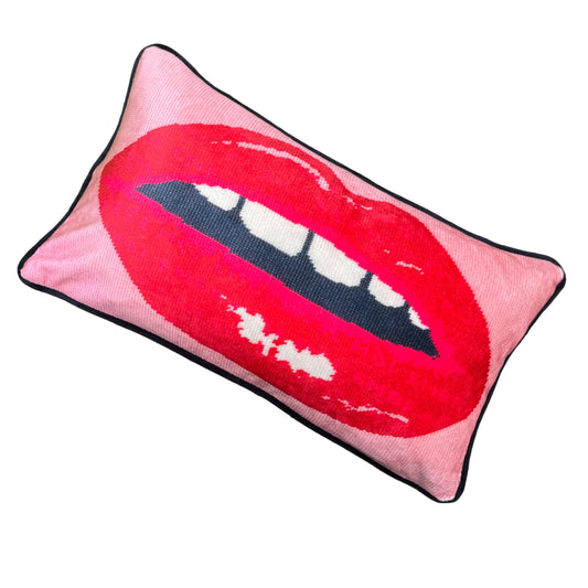 pink velvet lumbar pillow with red lips with open mouth and gapped teeth