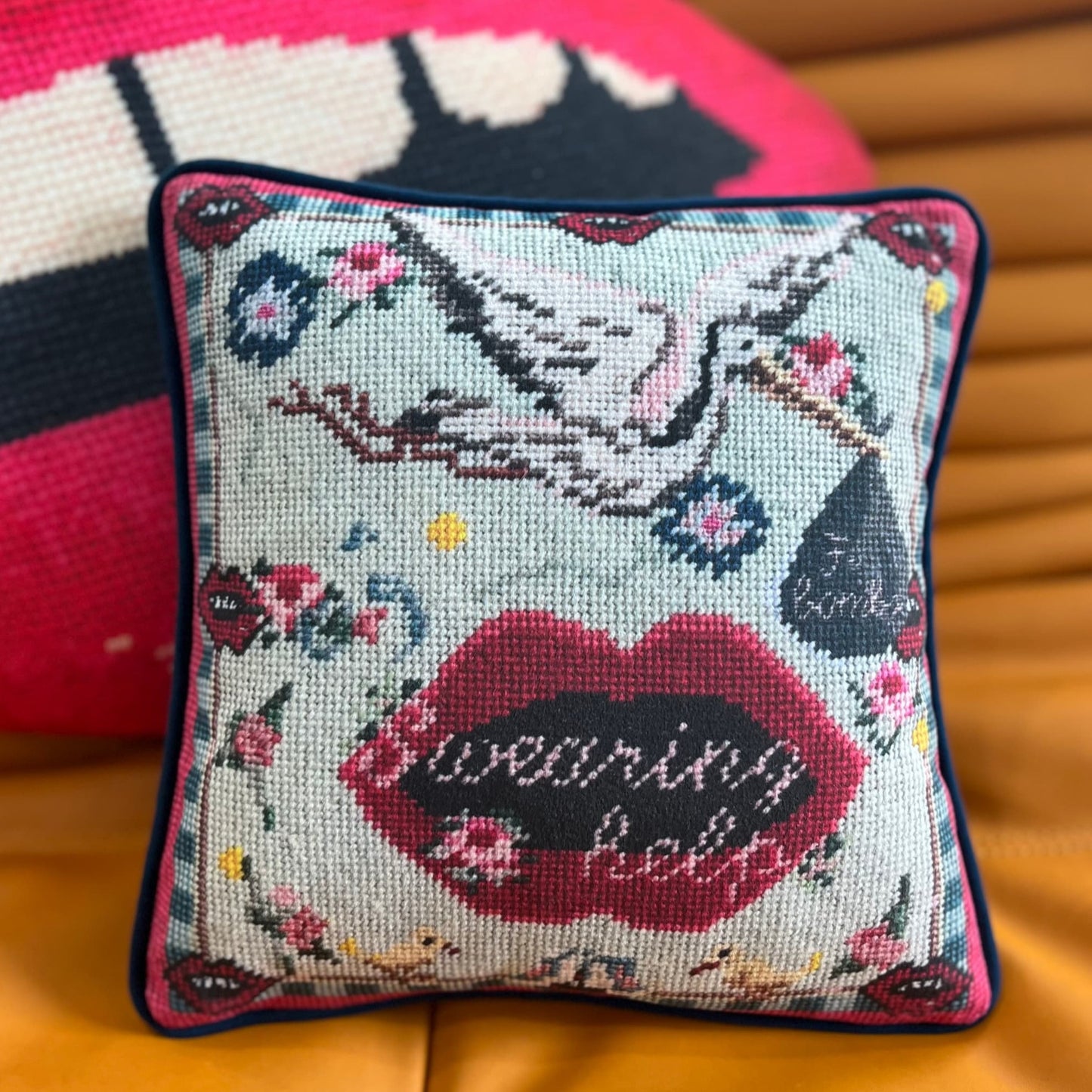 funky pillow with stork carrying f-bombs and big lips