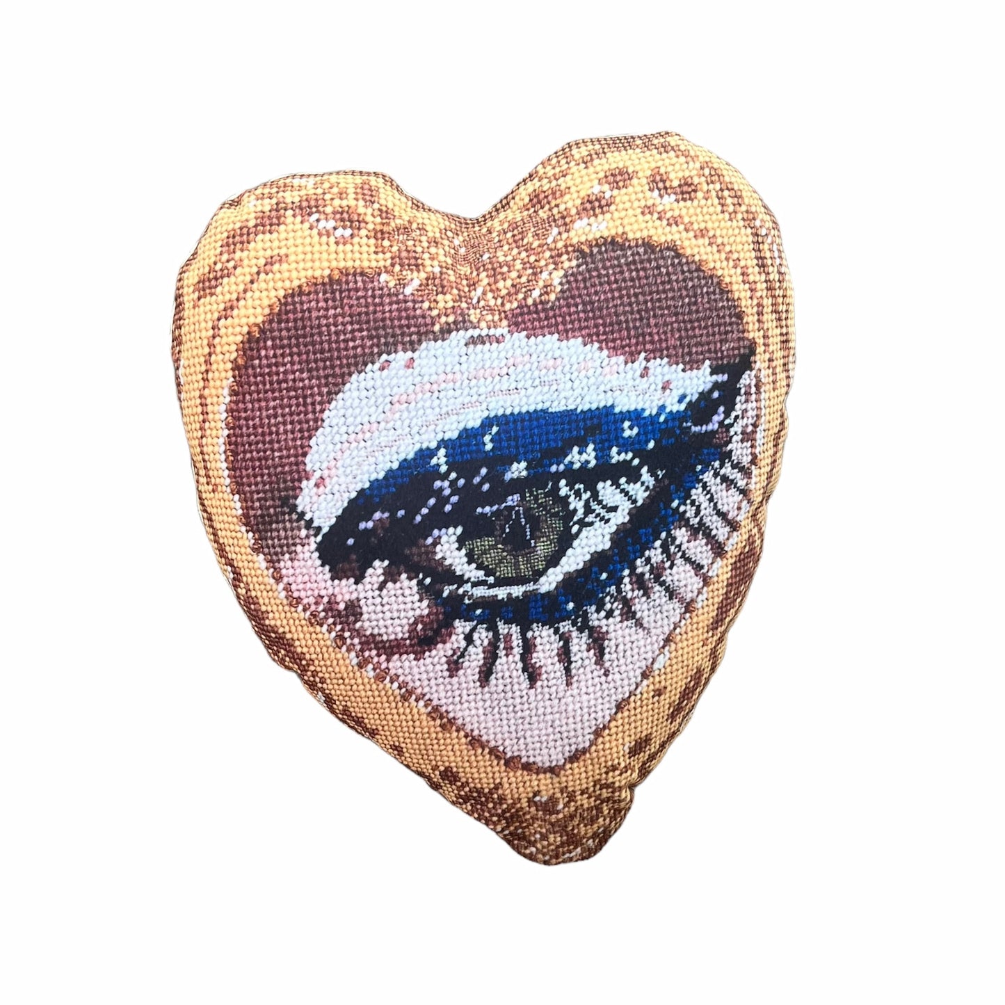 Mommani Threads x Haricot Vert "Heartfelt Glimpse" pillow is shaped like a heart and features a sultry green eye inside a gold frame.