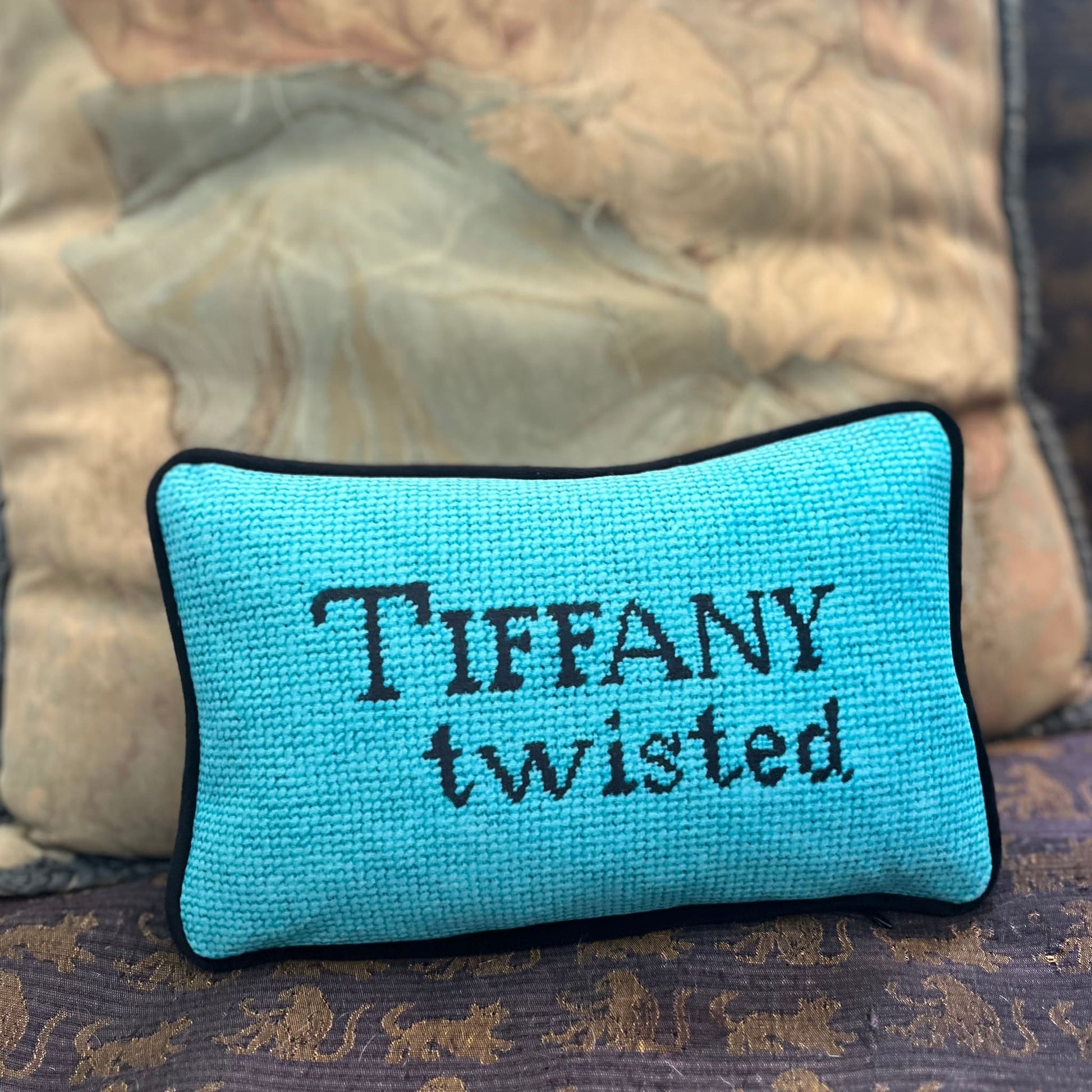 Tiffany blue pillow with black letters reading "Tiffany Twisted"