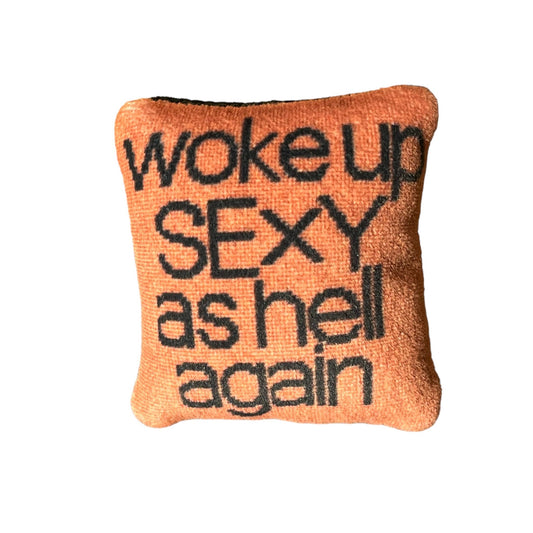 woke up sexy as hell in black, centered on pillow with copper background