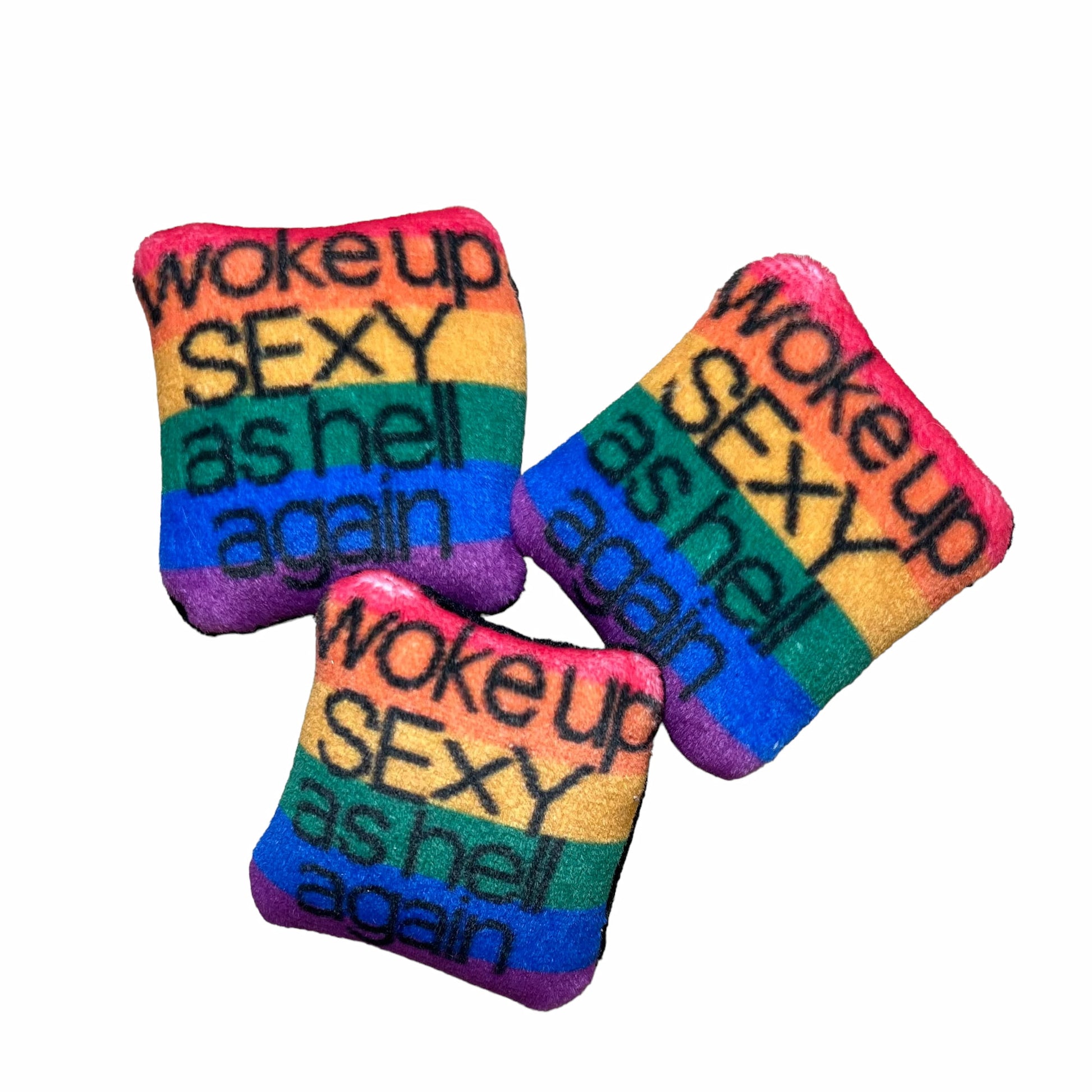 black text with woke up sexy as hell again centered on pillow on rainbow flag background
