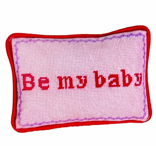 Pink velvet pillow with red letters that say "Be My Baby"; lavender wavy border.