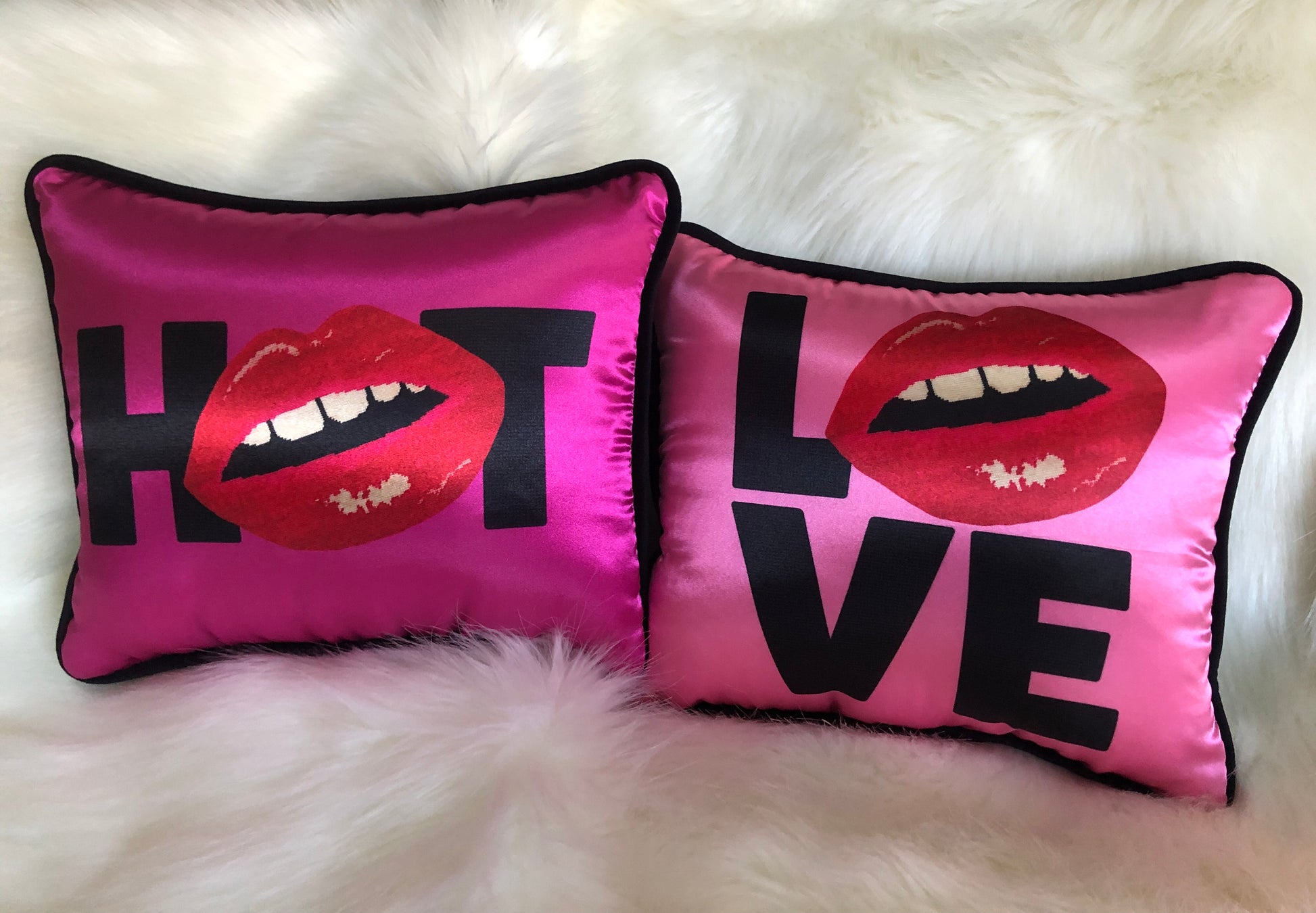 hot pink pillow with blackletters - L, red lips for an O, V & E stacked underneath with H (lips) T magenta pillow