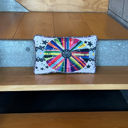 pillow center is dark gray with white fist pump, rainbow circle radiates out with GONNA START A REVOLUTION, cloud and stars border