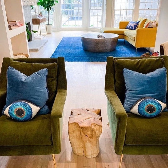 blue eye sculpted pillow has gold in center, turning to turquoise, then deep blues, contemporary chair vignette