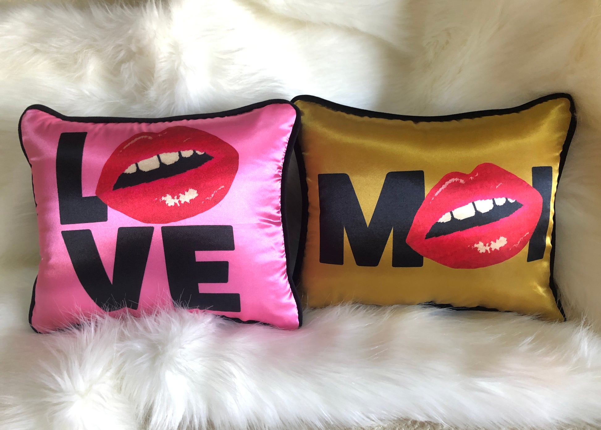 hot pink pillow with blackletters - L, red lips for an O, V & E stacked underneath & gold pillow with M (lips) I