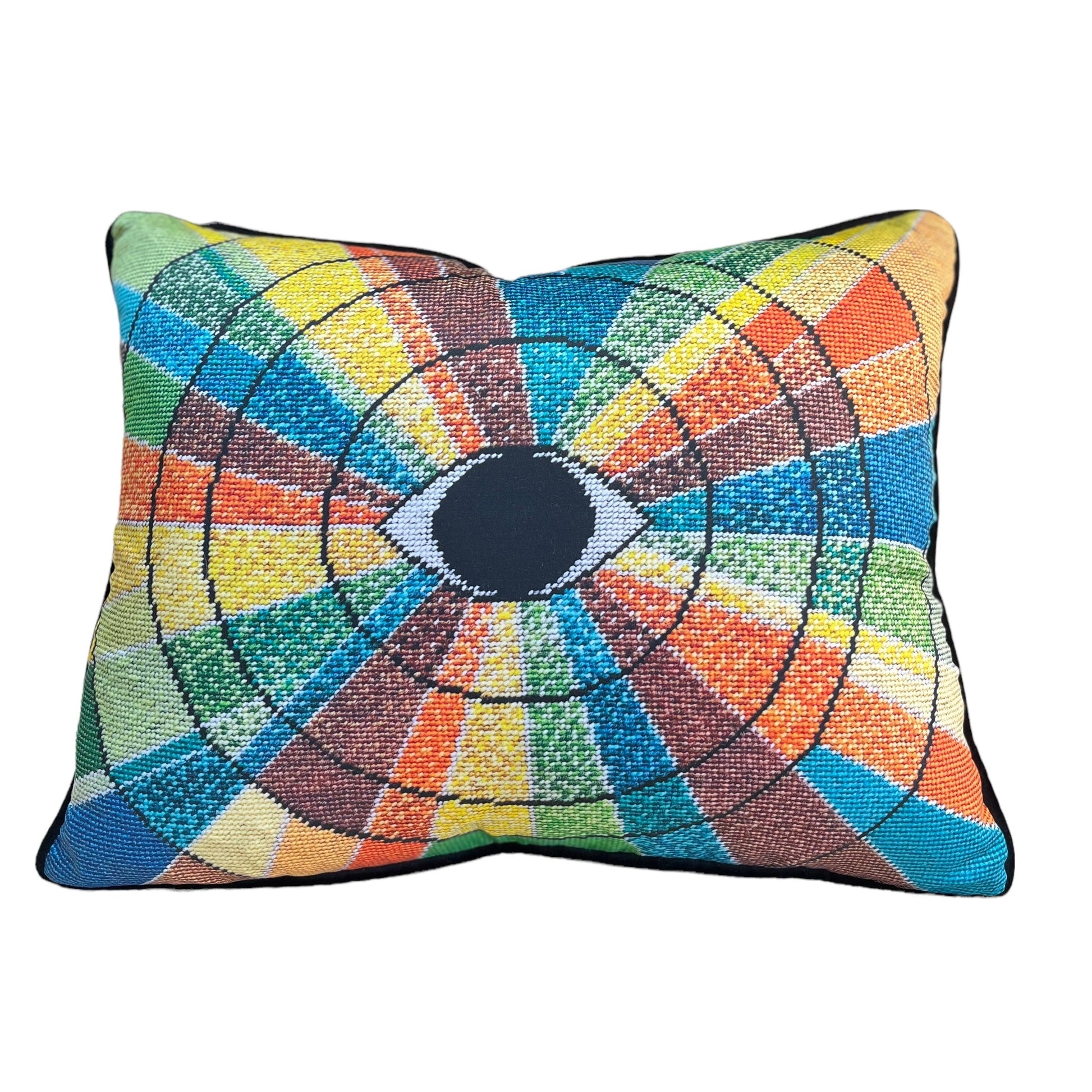 pillow has eye centered design with variegated rays of color - turquoise, green, brown, orange, yellow