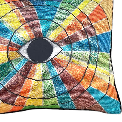 pillow has eye centered design with variegated rays of color - turquoise, green, brown, orange, yellow
