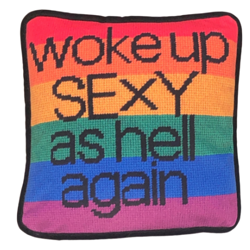 black text with woke up sexy as hell again centered on pillow on rainbow flag background